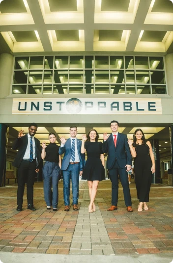 FIU students under a sign that says Unstoppable